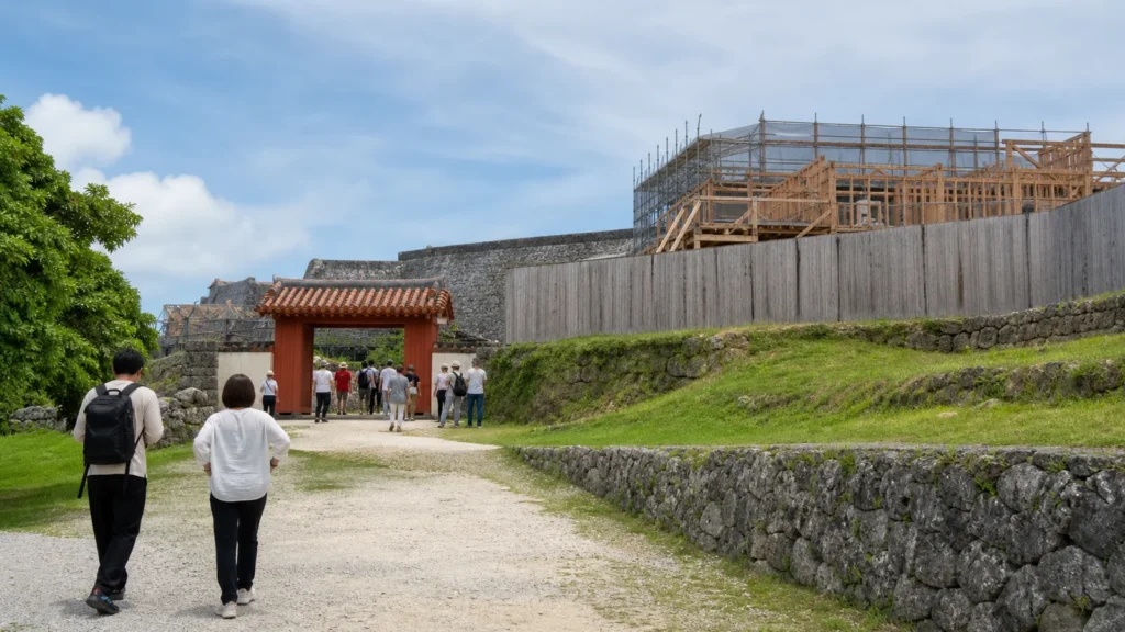 復元工事が進む沖縄の城跡公園を歩く旅行者