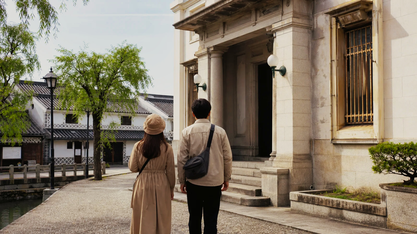 白壁と石造りの美術館入口へ向かう倉敷の旅行者
